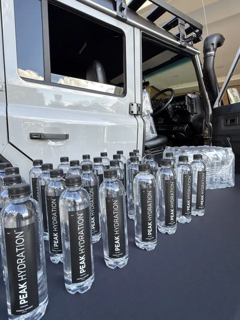 Rows of Peak Hydration bottles ready for an event